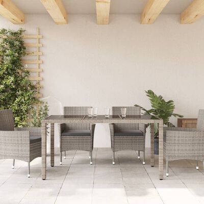 vidaXL Mesa de jardín superficie de vidrio ratán PE gris 150x90x75 cm